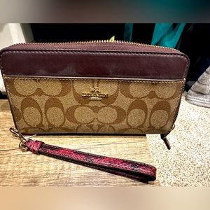 NWOT Coach Wallet with maroon trim and strap.